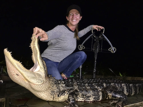 Woman hunting an alligator at night with a crossbow in Florida.