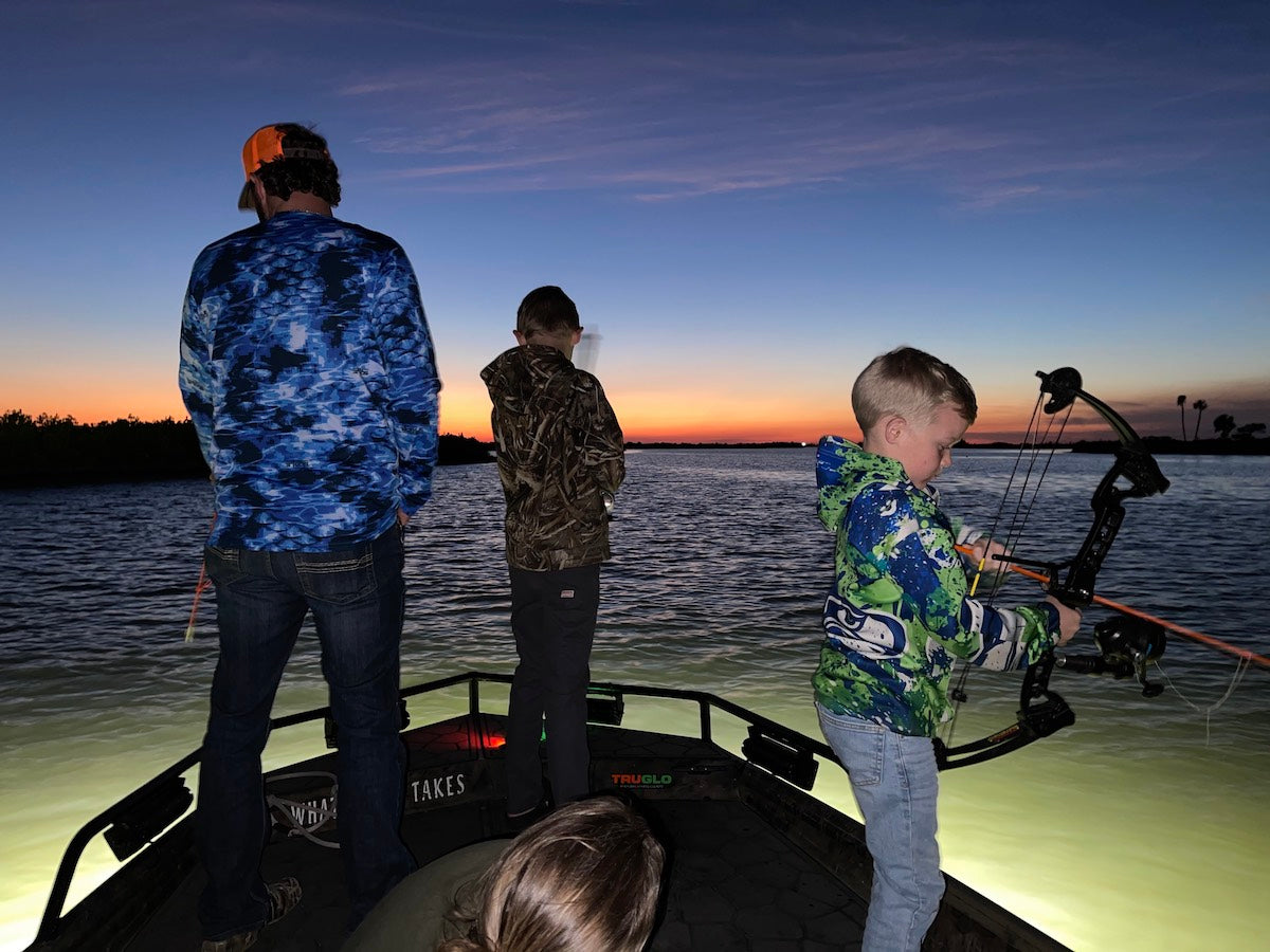 Kids bowfishing at night in Crystal River, Florida. 
